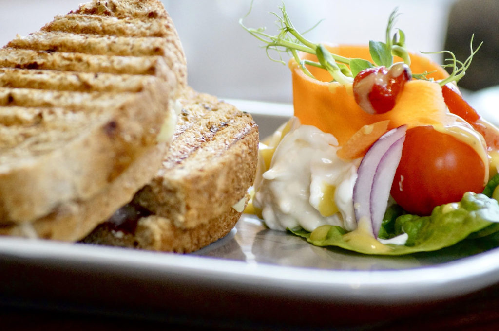 A golden toastie with dressed salad garnish
